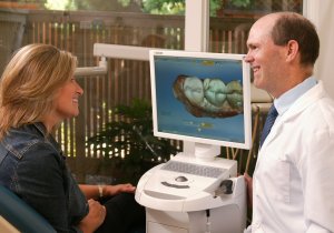 Dr. Randall Murray, helping a dental crown patient