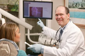 Dr. Randall Murray, helping a patient understand dental treatment