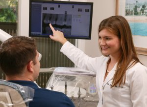 Dr. Sarah Murray, helping a dental patient